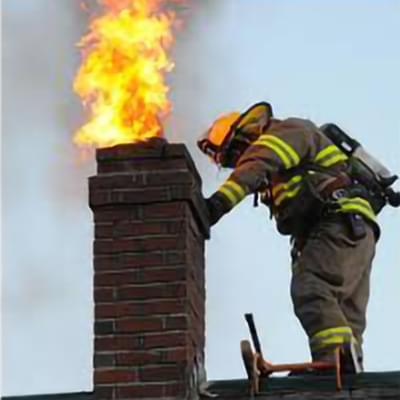 Firefighter putting out chimney fire